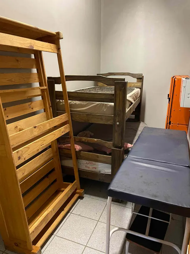 CONTENTS OF ROOM: EXAMINATION BED, DOUBLE BUNK WITH ONE MATTRESS & SINGLEBED WOODEN FRAME