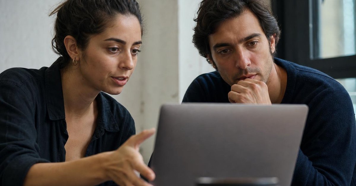AI founders reviewing runway plans and funding milestones with an investor at a shared table
