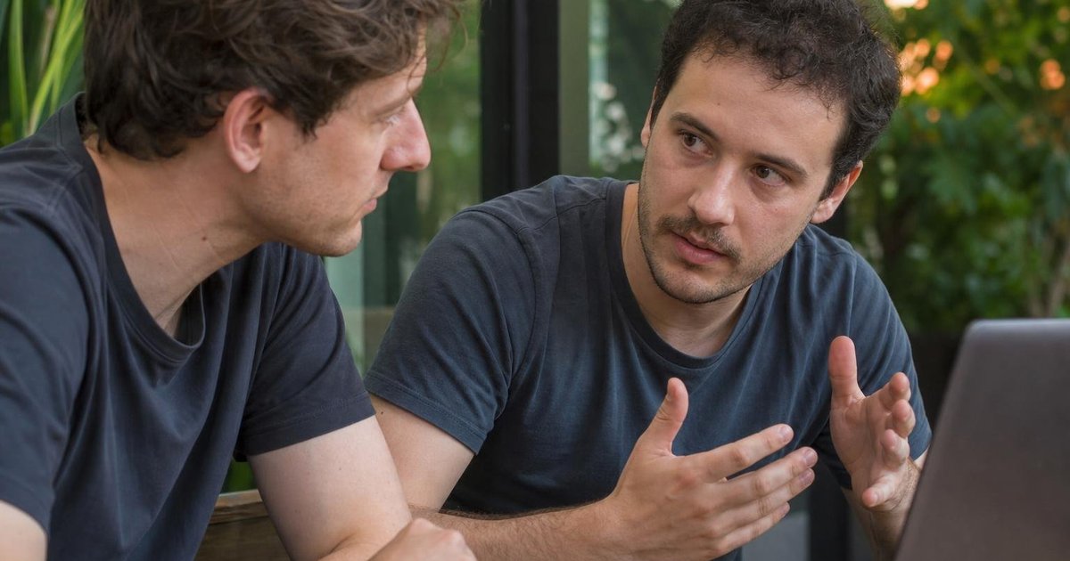 Australian startup founders discussing AI tools and feedback in a close-up candid community meetup