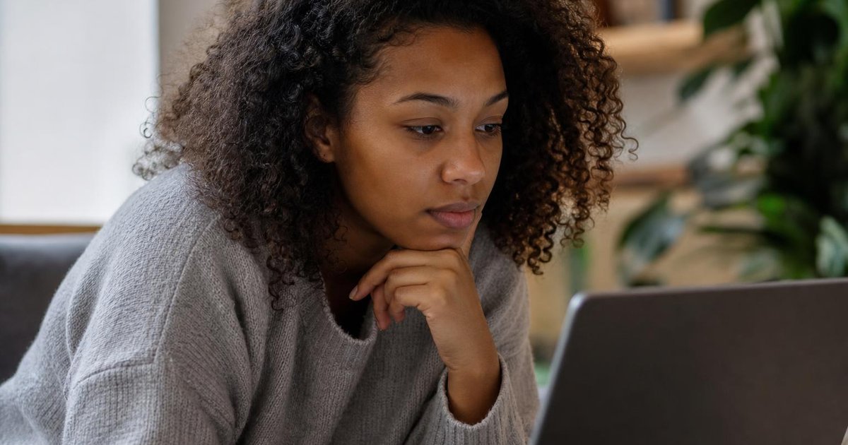 Close-up of people using AI tools on laptops and phones in a candid workspace moment