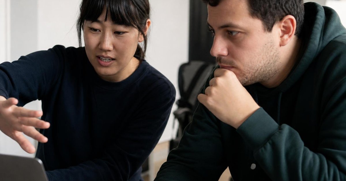 AI startup founders reviewing accelerator program notes during a candid close-up meeting