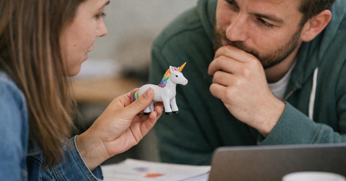 Startup founders reviewing unicorn startup valuation on a laptop in a candid