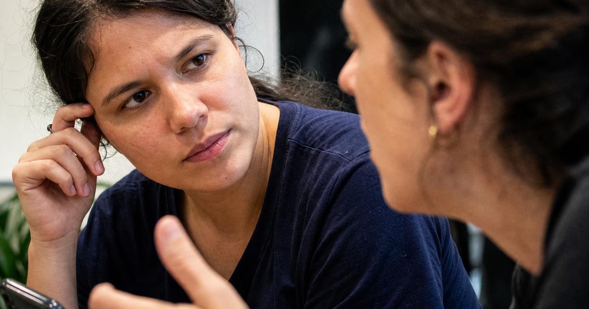 Ultra close-up of diverse founders in a skeptical conversation about customer demand and market fit