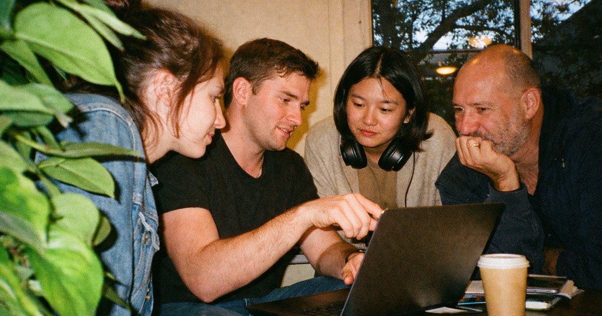 Diverse group collaborating in a 90s tech startup, preparing for structured user recruitment sessions.