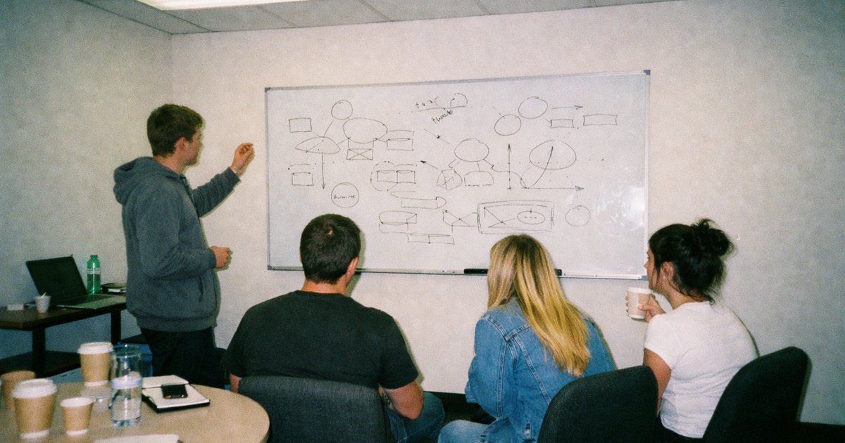 People collaborate in a vibrant tech and startup environment, reflecting a 90s film aesthetic, embodying innovation in Victoria.