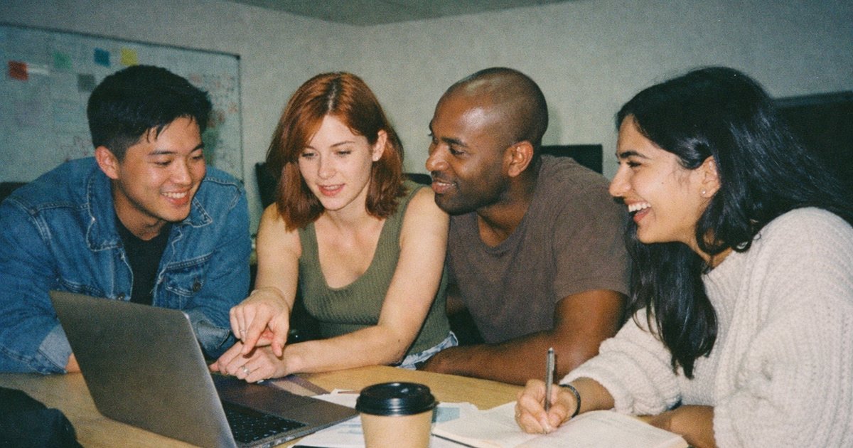 90s film aesthetic captures a diverse group brainstorming in a vibrant tech startup office.