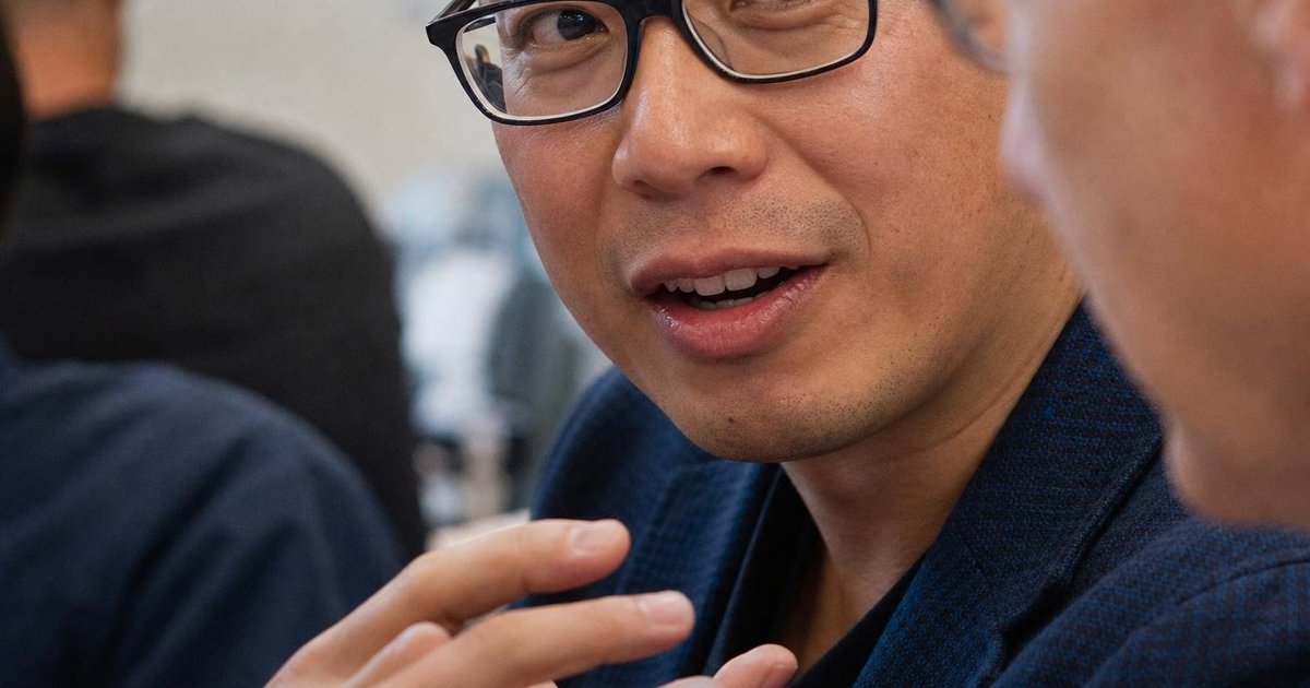 Close-up of founders swapping business cards at a Sydney startup meetup for AI networking
