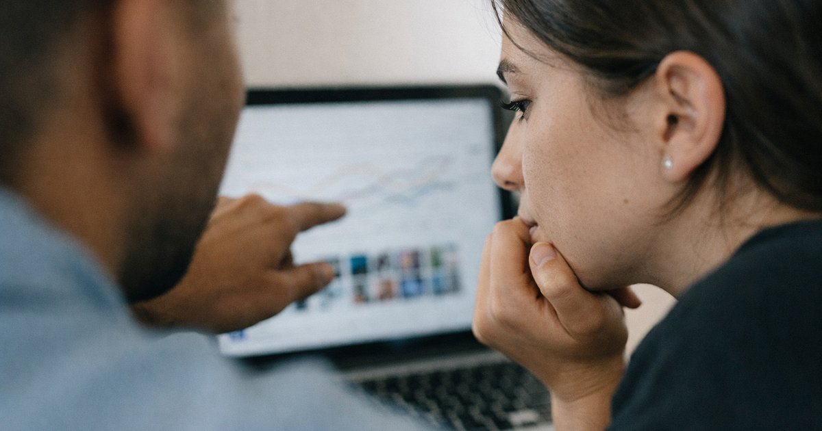 Close-up of hands comparing charts