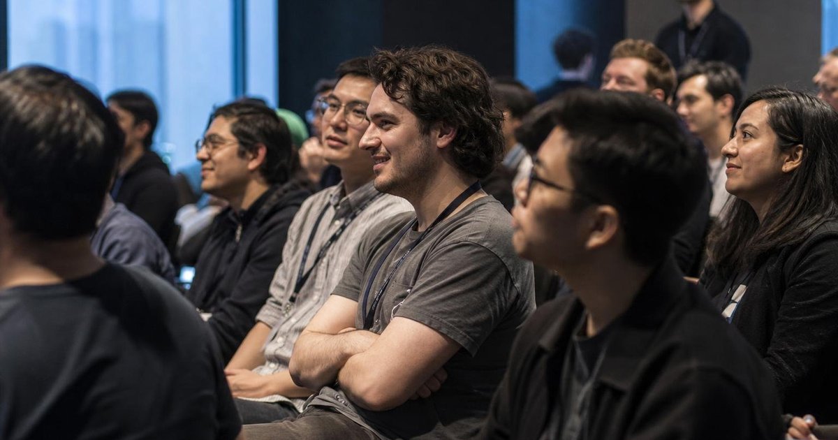 People networking during an AI research talk in a modern Melbourne university innovation precinct