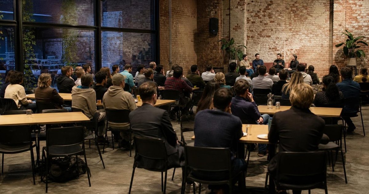 Attendees networking at a Melbourne AI event hub during a candid monthly planning meetup