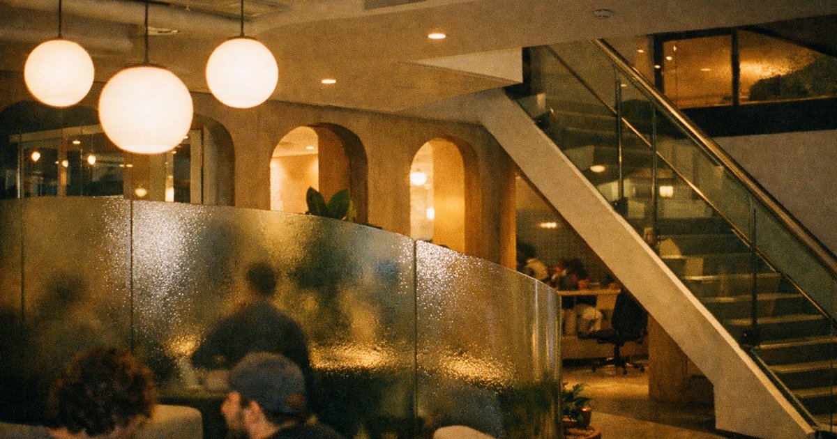 Nineties film-style scene of a tech startup team collaborating in a vibrant office space.