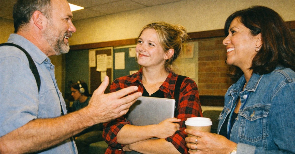 People engaged in a 90s tech startup, surrounded by retro gadgets, illustrating distraction and attention costs.