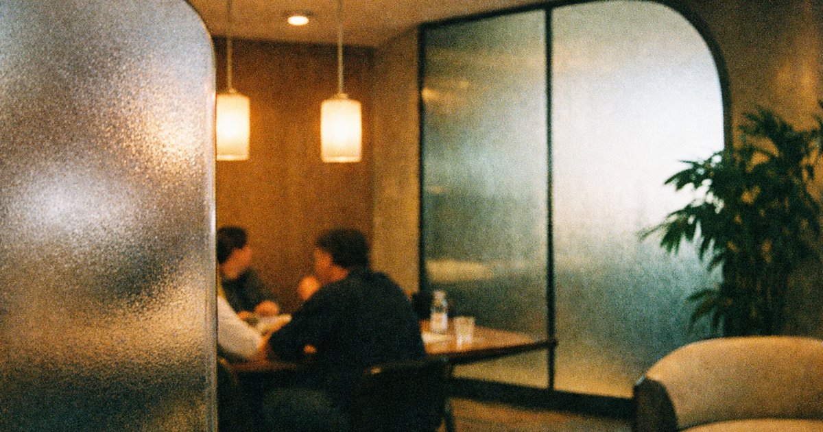 Team collaborating in a retro tech startup, showcasing 90s film aesthetics and innovative investment strategies.