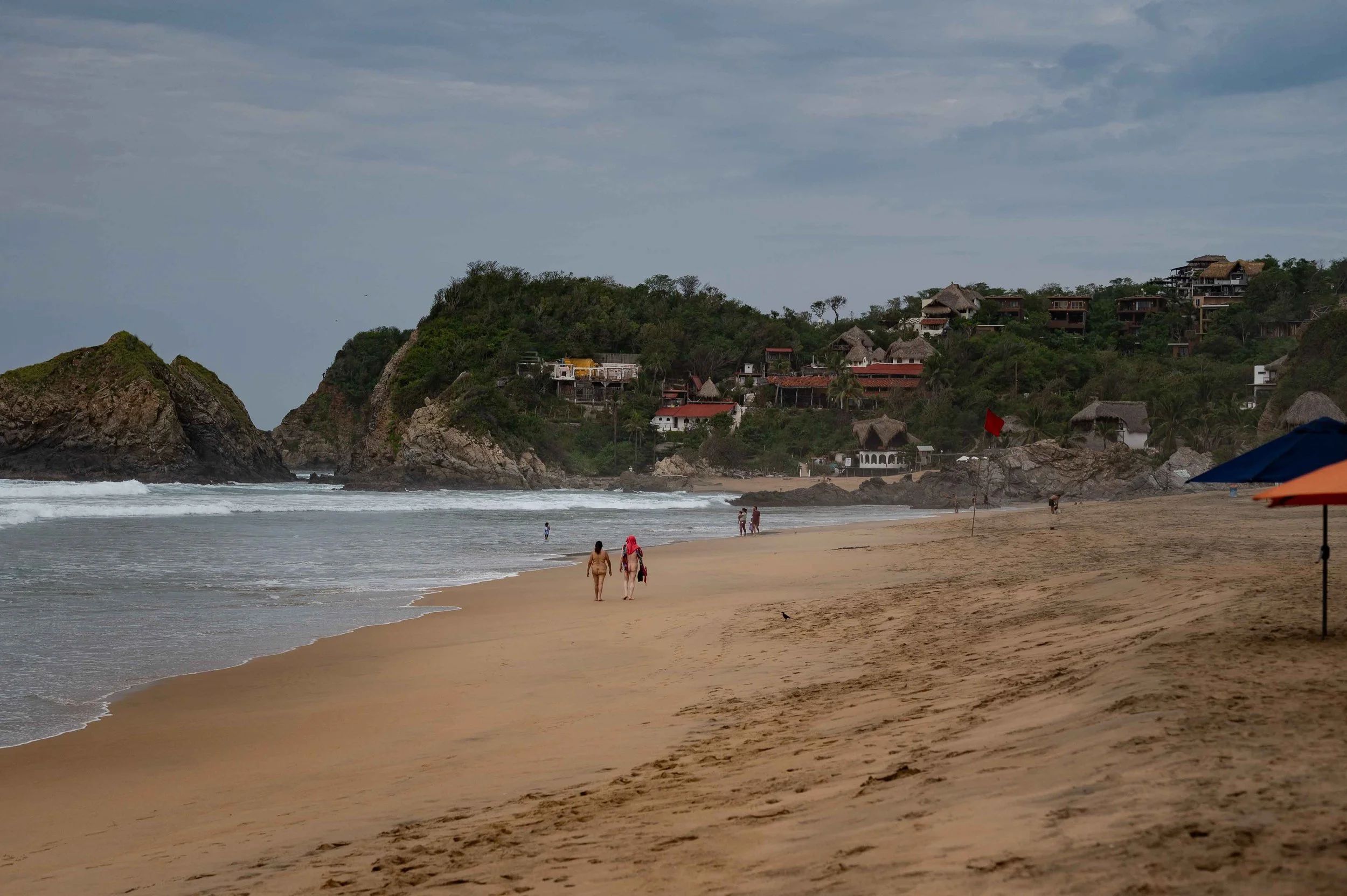 Sun-drenched California coastline, secret nude-friendly beach, adventurous travel vibe.