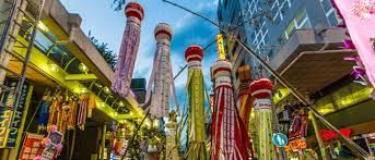 Gloomy Kobe cityscape, rain-slicked streets, stark regret of a traveler leaving tranquil Sendai.