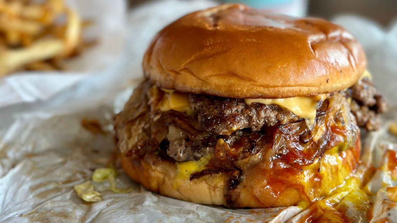 Grim Tulsa diner, greasy fried onion burger, stark light, unappetizing reality, local food secrets.
