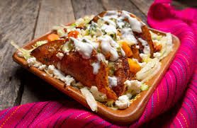 Vibrant enchiladas potosinas, a spicy culinary secret of San Luis Potosi, bathed in warm, inviting light, evoking authentic Mexican dining.