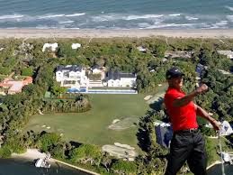 Opulent Miami mansion, reflecting Tiger Woods' exclusive lifestyle, bathed in golden twilight.