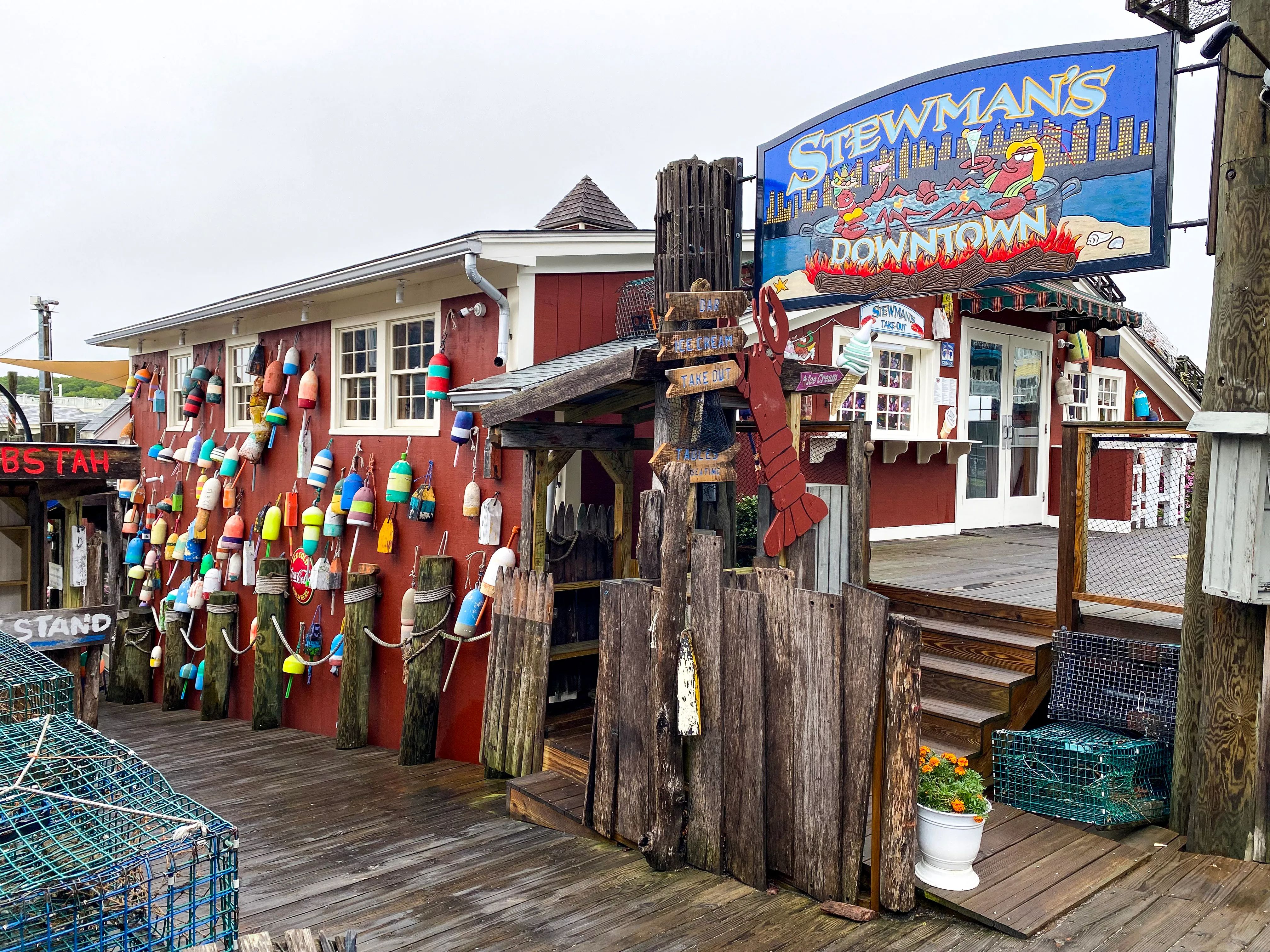 Coastal Maine fog parting to reveal a lone car on a dramatic, cliffside highway, hinting at a challenging but epic journey.