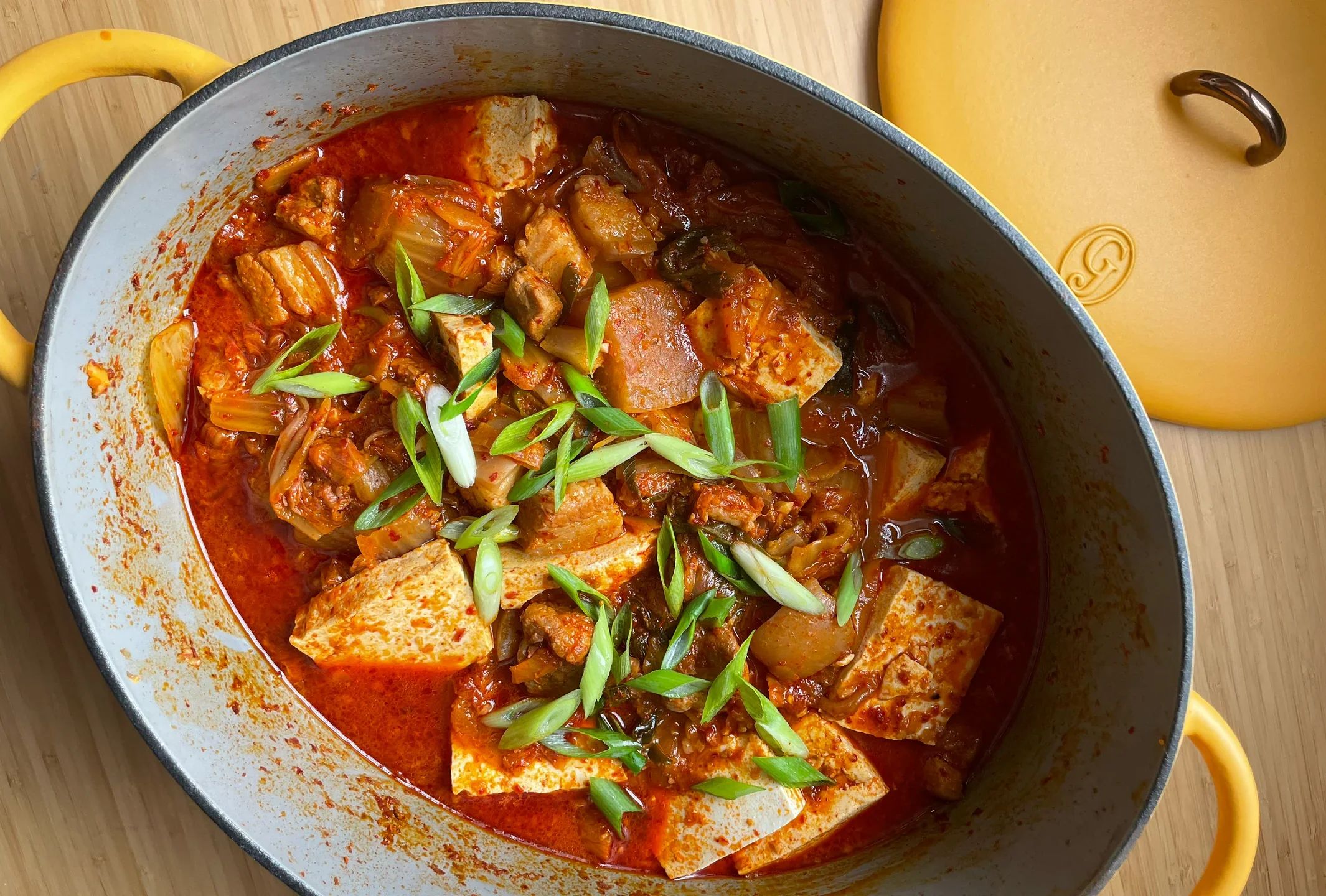 Steaming kimchi jjigae, a flavorful Daejeon delight, radiating warmth and local authenticity.