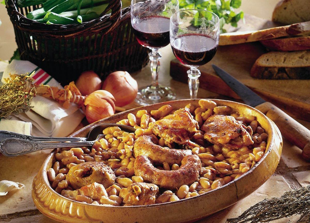 Rich, bubbling cassoulet, a Toulouse culinary secret, beckons with savory French cooking aromas.