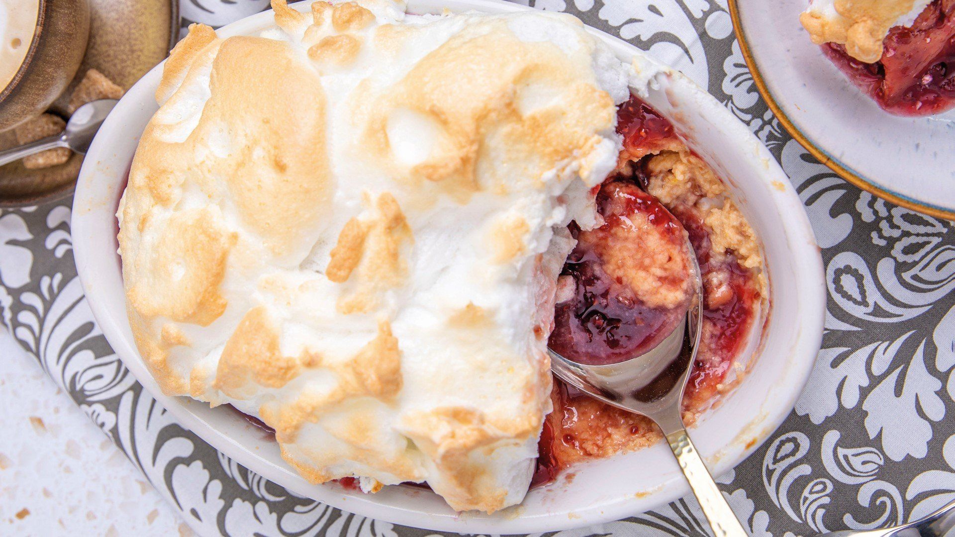 Historic Oxford pub, warm light, revealing a traditional English dessert, a culinary travel secret.