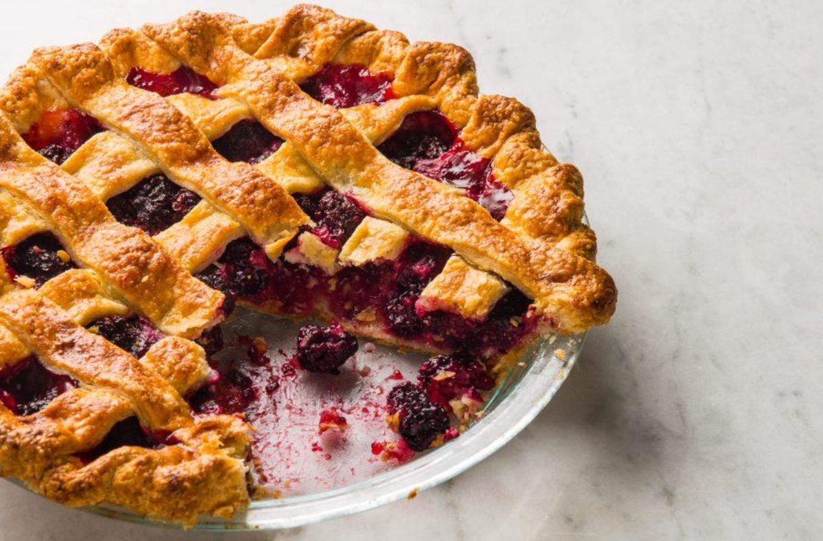 Warm, rustic marionberry pie, Portland's bold culinary secret, inviting home bakers.