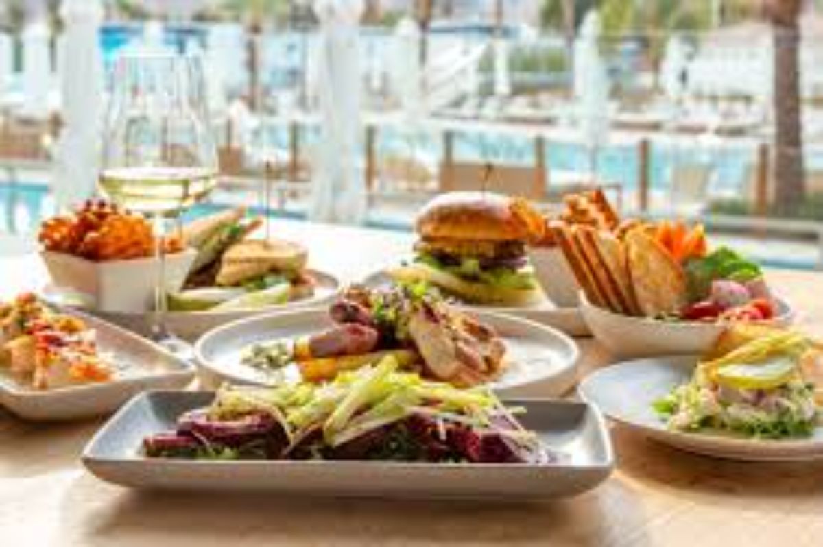 Tantalizing buffet spread, warm California sunlight, exciting dining discovery in Irvine vs. Palm Springs.