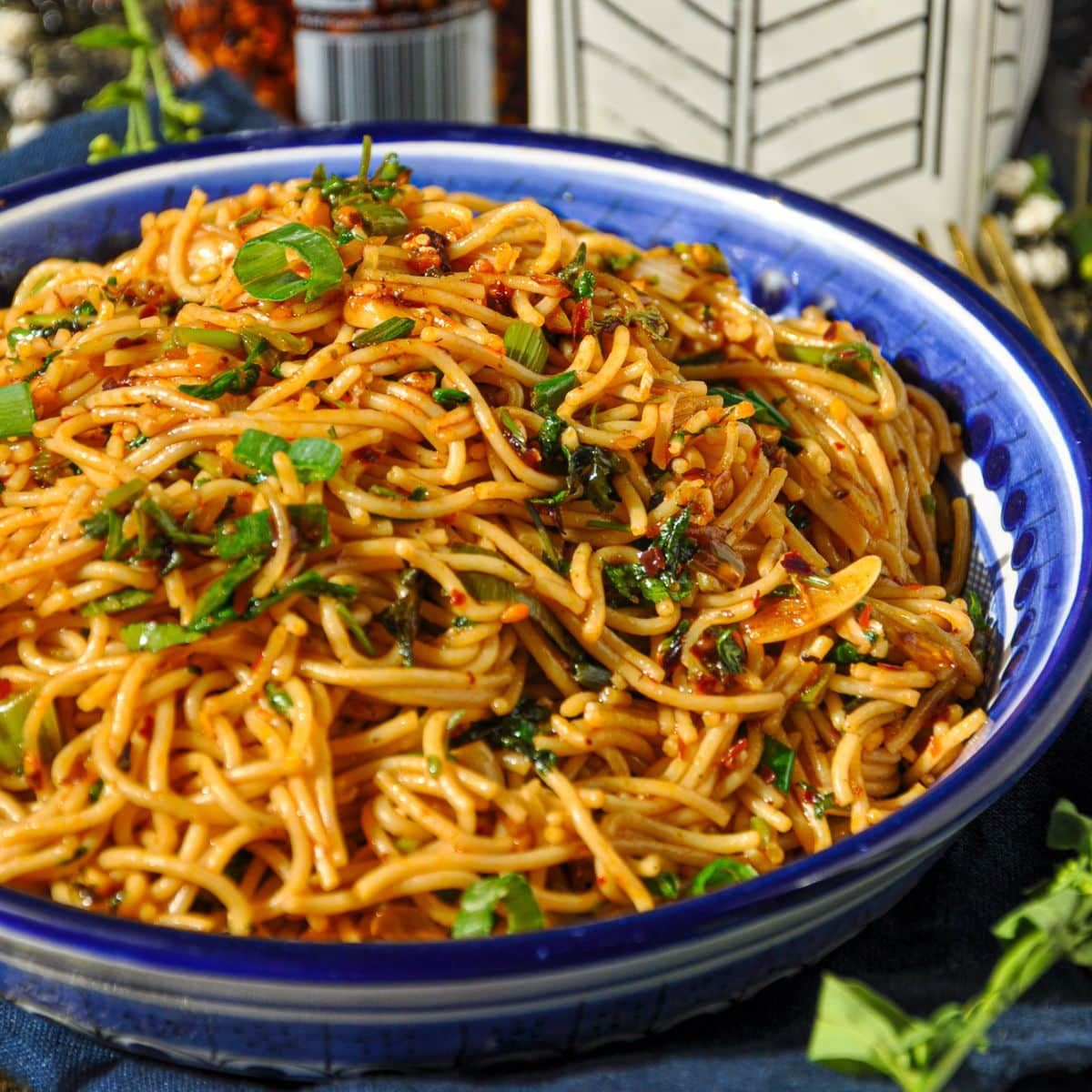 Steaming spicy garlic noodles, an Irvine culinary secret, evoke a vibrant, hidden gem dining mood.