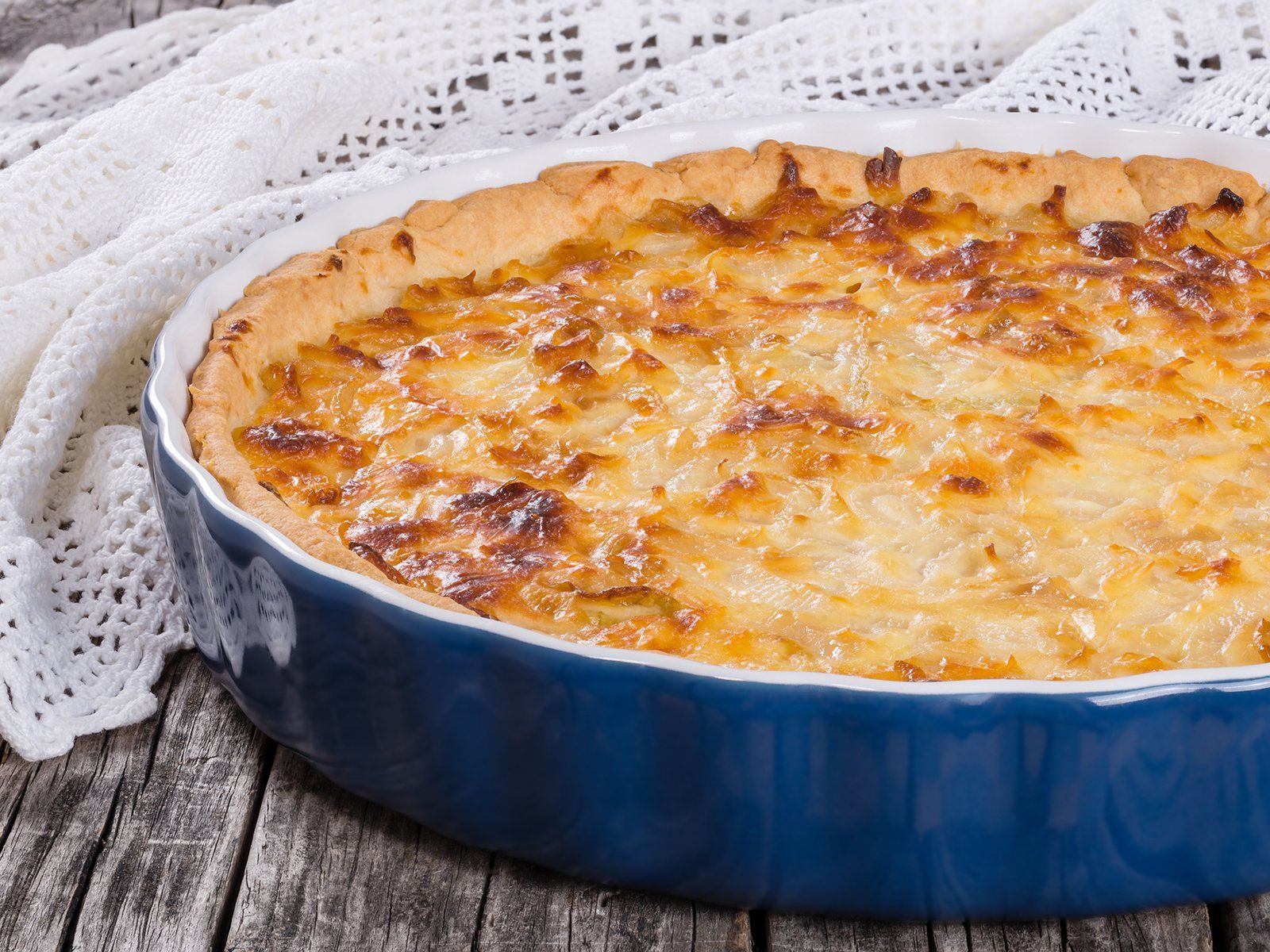 Golden Zwiebelkuchen, warm Basel kitchen glow, inviting Swiss culinary discovery.