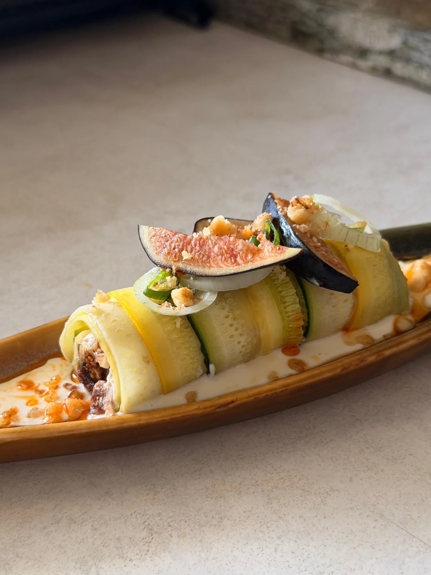 Stuffed zucchini roll with ricotta cream, figs, and walnuts