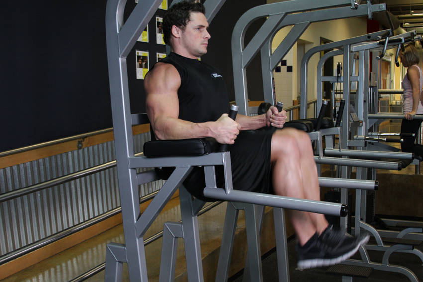 Knee/Hip Raise On Parallel Bars — end position, working the abs