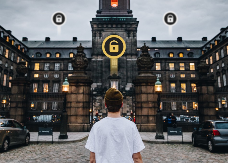 Man seen from behind standing in front of Christiansborg.