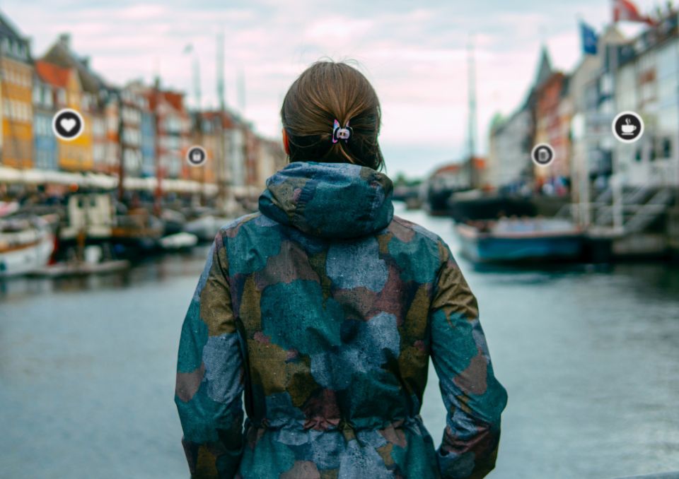 Women seen from behind standing in Nyhavn, Copenhagen.