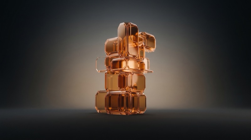 Amber Glass Geometric Sculpture on Dark Background