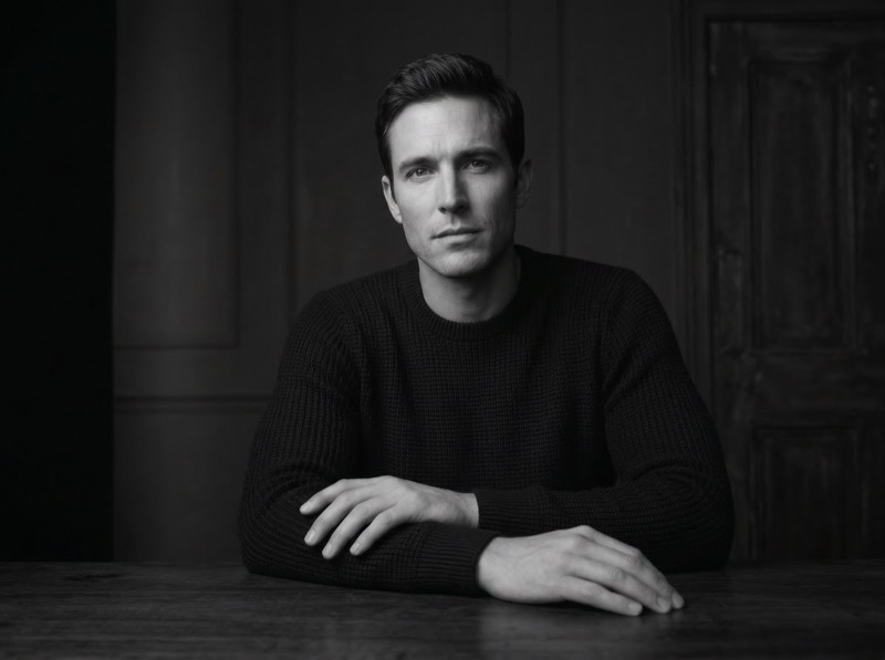 Black and white studio portrait of a man