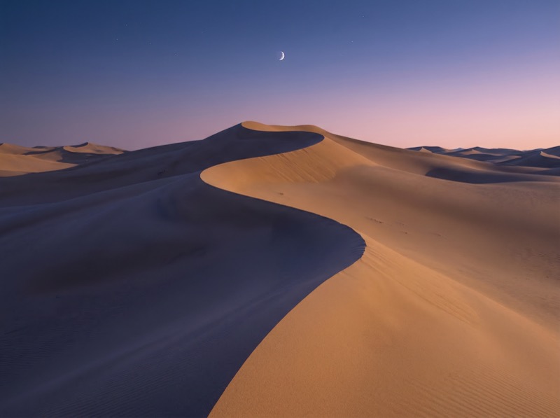 Crescent Moon Over Desert Sand Dunes at Dusk