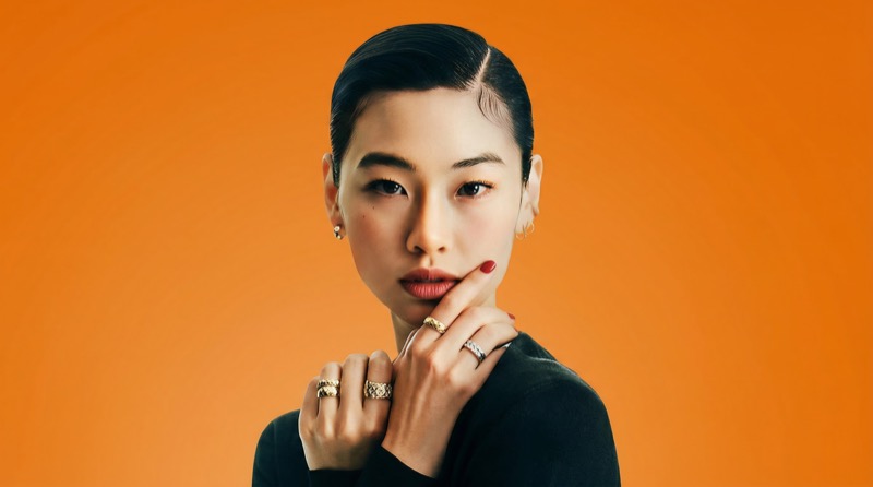 Elegant portrait with jewelry on orange background