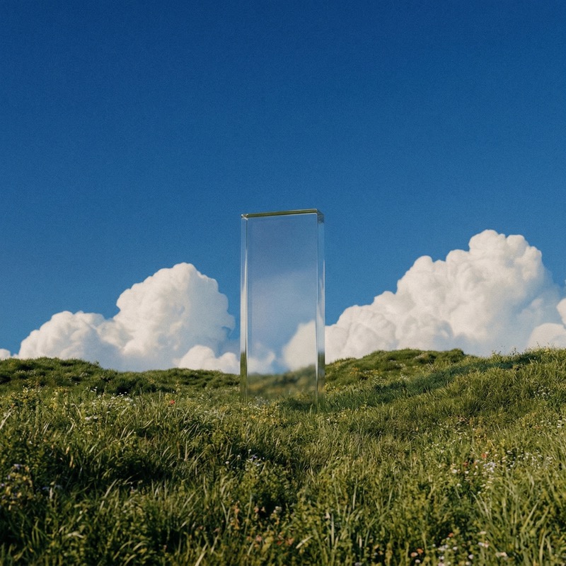 Glass Monolith in Meadow Under Blue Sky