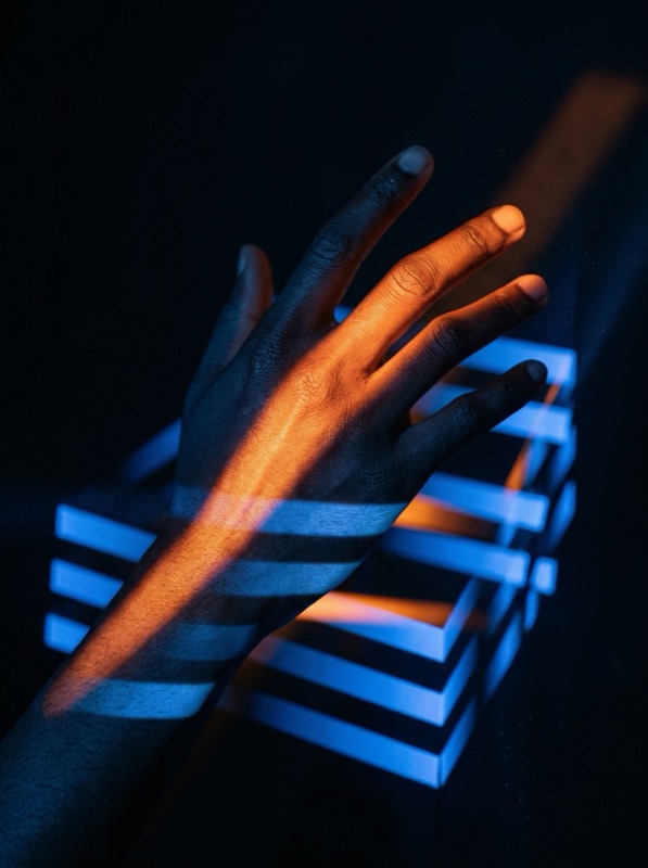 Ultra Realistic Cinematic Studio Photograph Of A Human Hand Reaching Into Intersecting