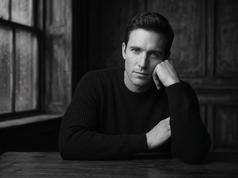 Moody black-and-white portrait of man indoors