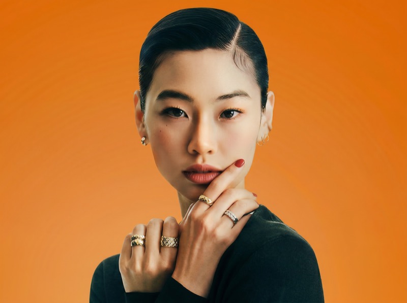 Studio beauty portrait with jewelry on orange