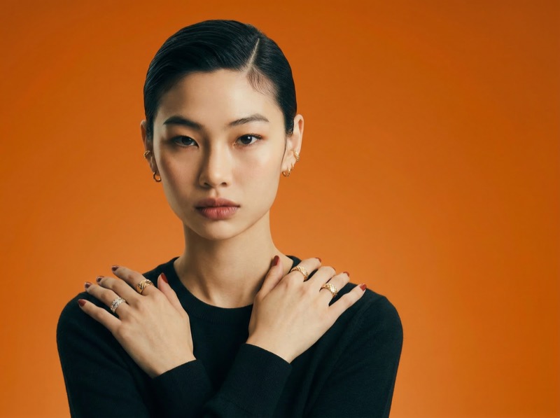 Studio portrait with orange background and jewelry