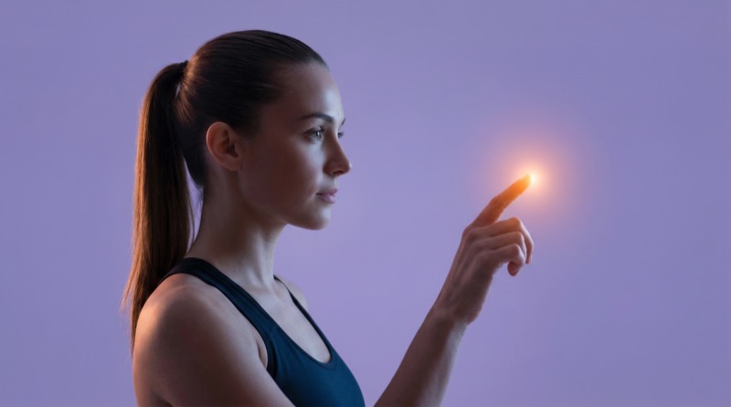 Woman touching glowing point on digital interface
