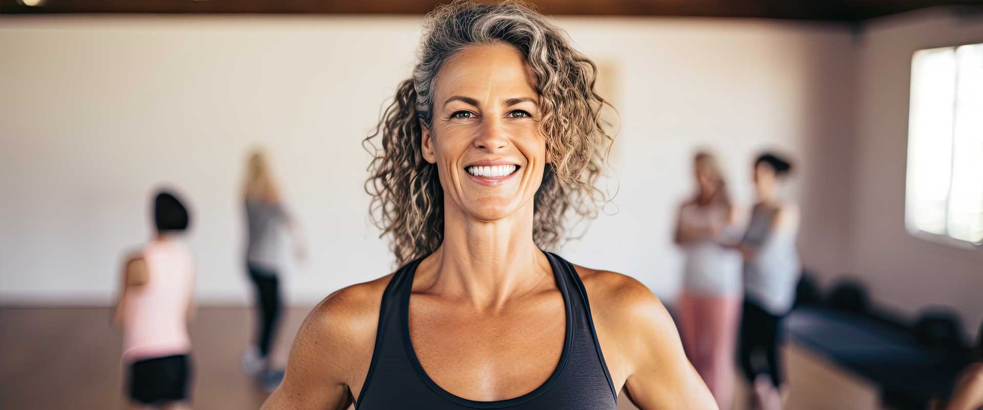 Experienced fitness trainer demonstrating strength training techniques to older adults, emphasizing safe and effective workouts for people over 50.