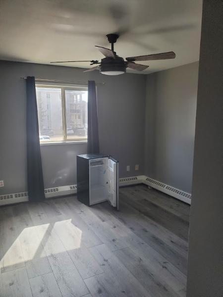 Unfurnished master bedroom with walk through closet and jacuzzi tub in bathroom