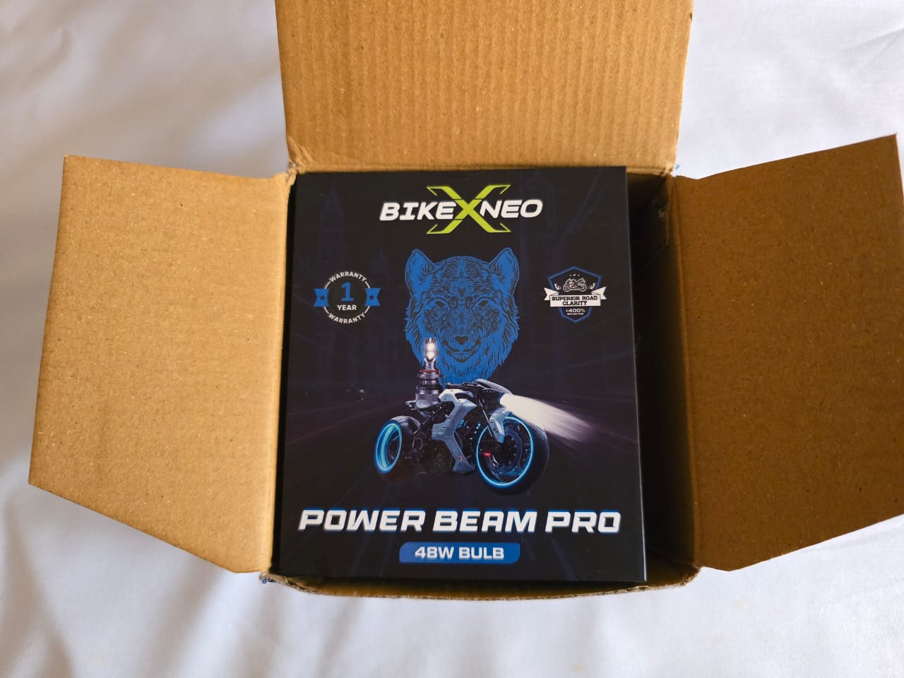 The sleek black retail packaging of the BikeX Neo Power Beam Pro 48W LED headlight bulb, featuring a dynamic graphic of a wolf above a motorcycle with blue illuminated wheels, and prominent branding that includes 'BikeX Neo', 'Power Beam Pro', and a '1 Year Warranty' badge.