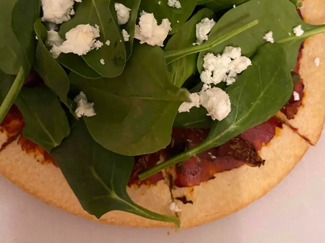 vegetarisch Pizza met spinazie, kappertjes en zongedroogde tomaat