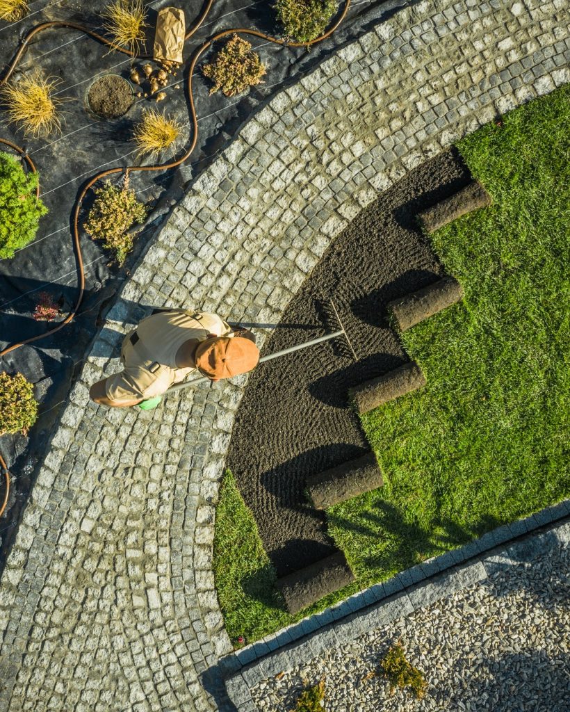Gardener in newly build backyard garden