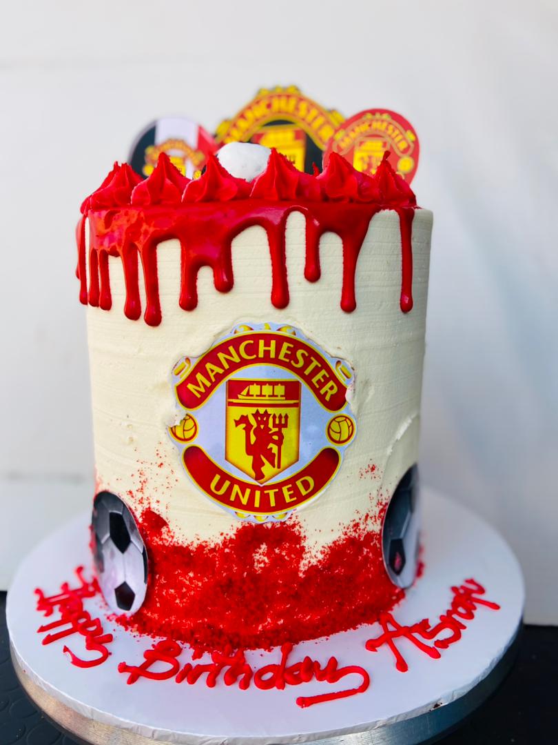 CREAMY,RED DRIPPED MANCHESTER CLUB CAKE 